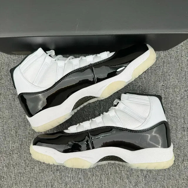 White and black Jordan 11 sneakers showing glossy black side panels
