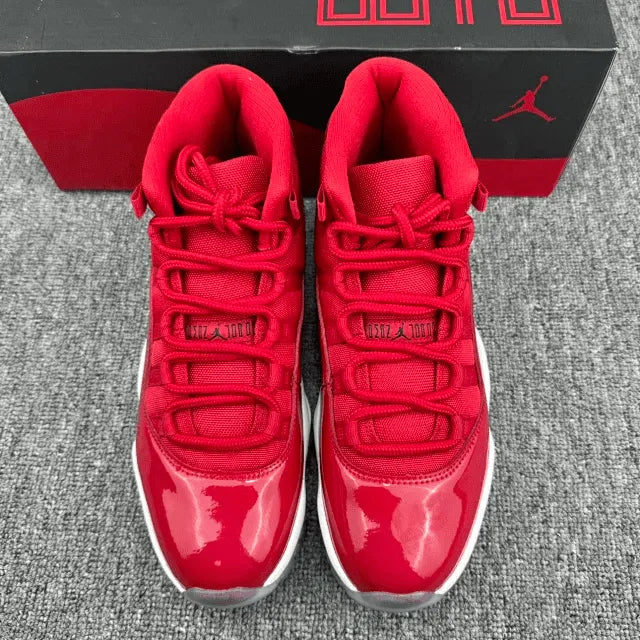 Red high-top sneakers with black Jumpman logo, white midsole, and blue outsole