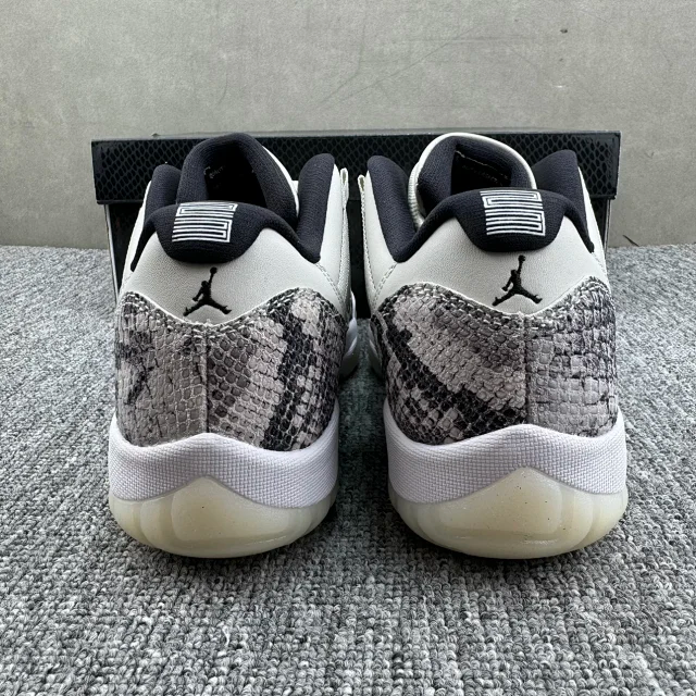 Low-top sneakers from back view with gray-and-black snakeskin heel and white midsole