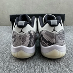 Low-top sneakers from back view with gray-and-black snakeskin heel and white midsole