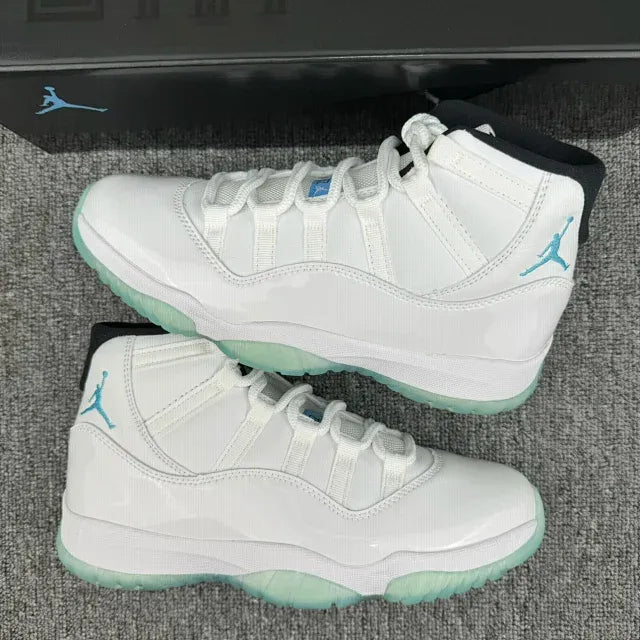 Two white Air Jordan 11 high-top sneakers, teal Jumpman branding and mint-green soles