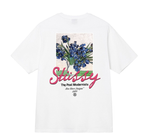 White Stussy T-shirt with blue floral graphic and pink Stussy logo on front