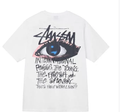Stussy white T-shirt with blue eye graphic and graffiti-style text