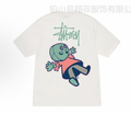 White graphic T-shirt with colorful cartoon character print and graffiti-style text
