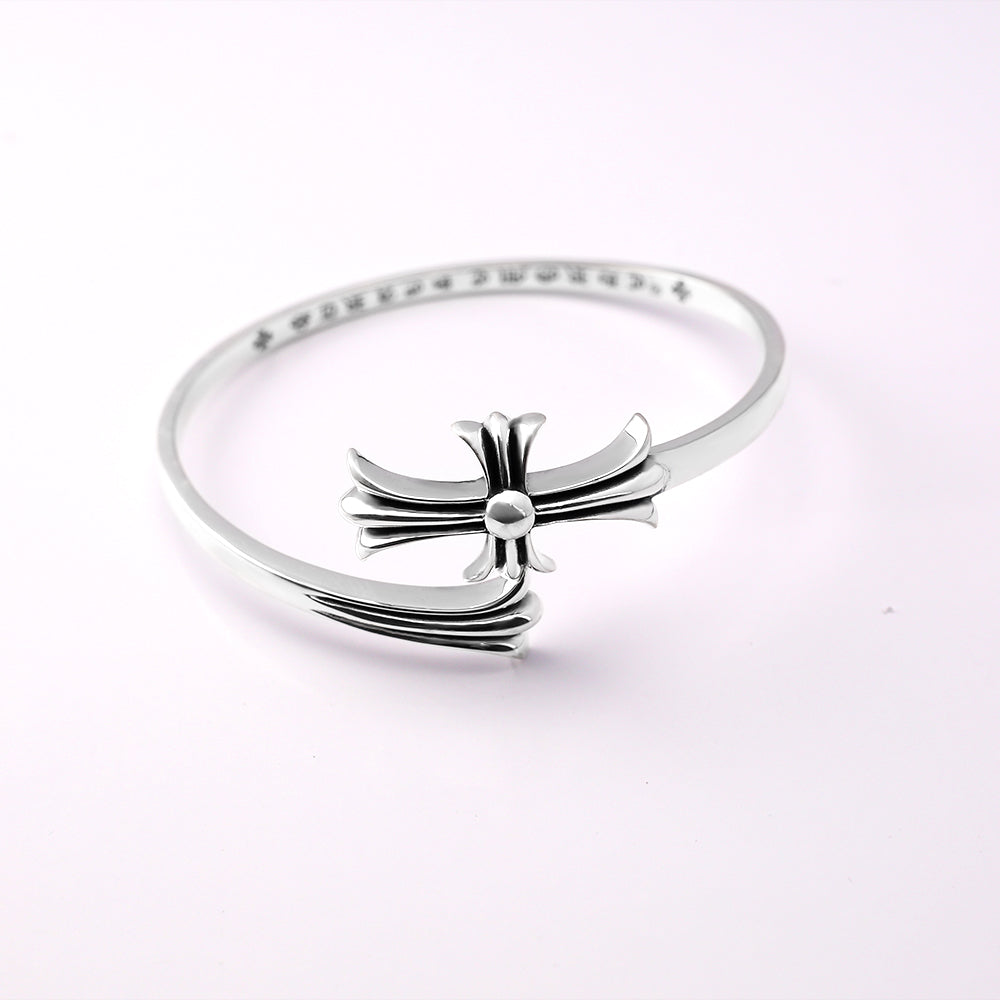 Chrome bangle bracelet with bow ornament centered on a slim pavé band