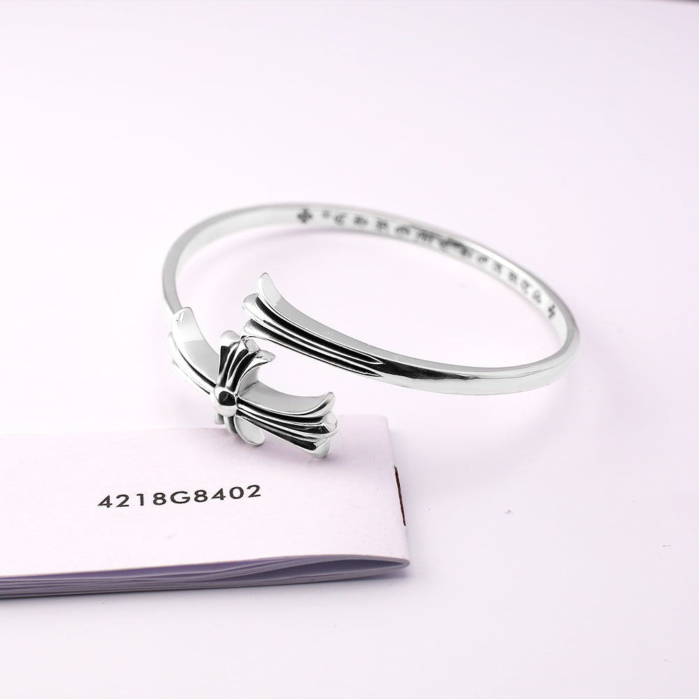 Chrome bangle bracelet with bow centerpiece and etched side pavé stones