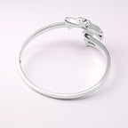 Chrome bangle bracelet from top view with engraved markings on the band