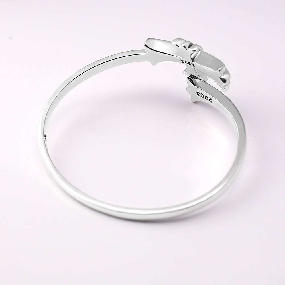 Chrome bangle bracelet from top view with engraved markings on the band