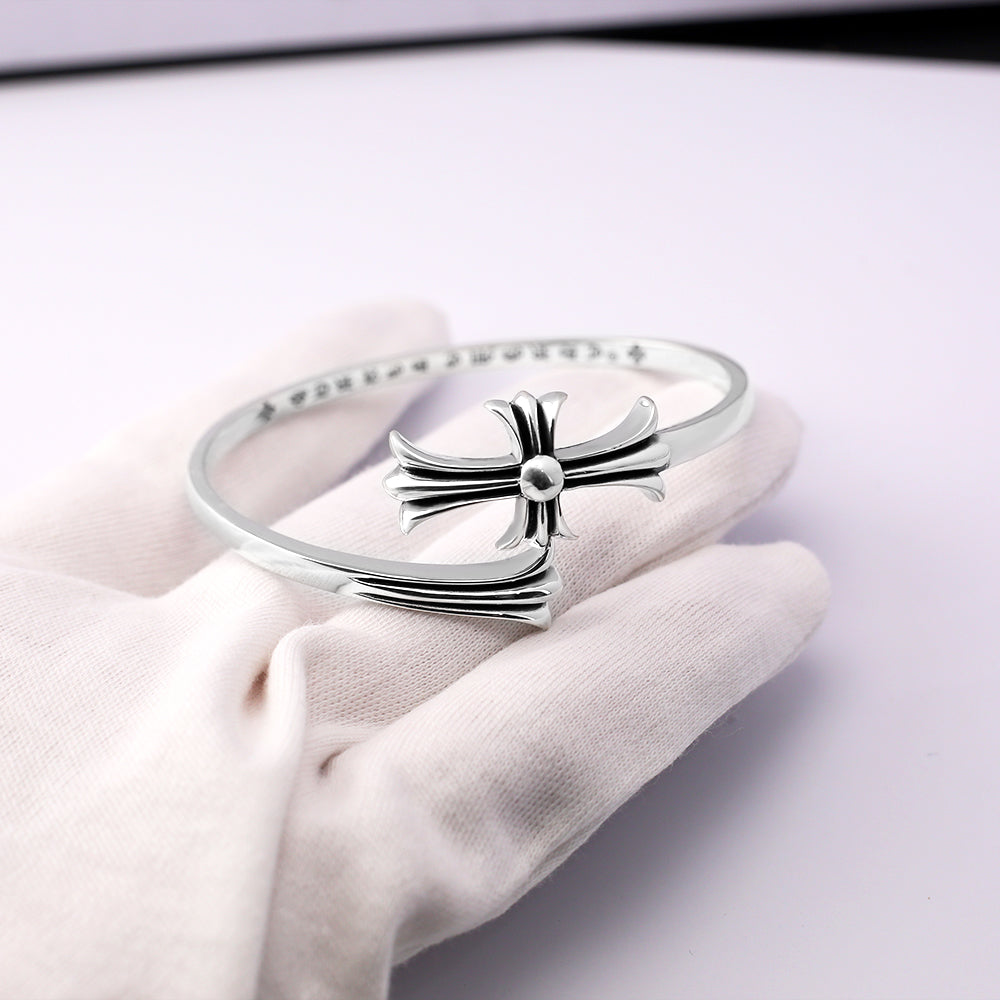 Chrome bangle bracelet with bow-shaped clasp and rhinestone pavé band