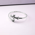 Chrome bangle bracelet with bow charm and sparkling pavé detail across the rim