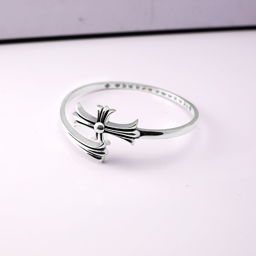 Chrome bangle bracelet with bow charm and sparkling pavé detail across the rim
