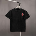 Black graphic T-shirt with small pink and blue cross emblem at left chest