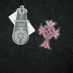 Black T-shirt front graphic with pink cross and white hang tag