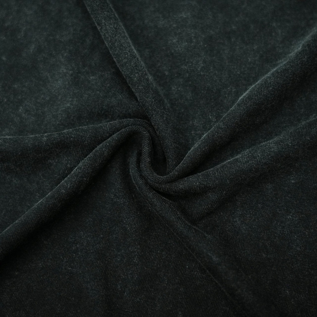 Black T-shirt fabric texture close-up with folded creases