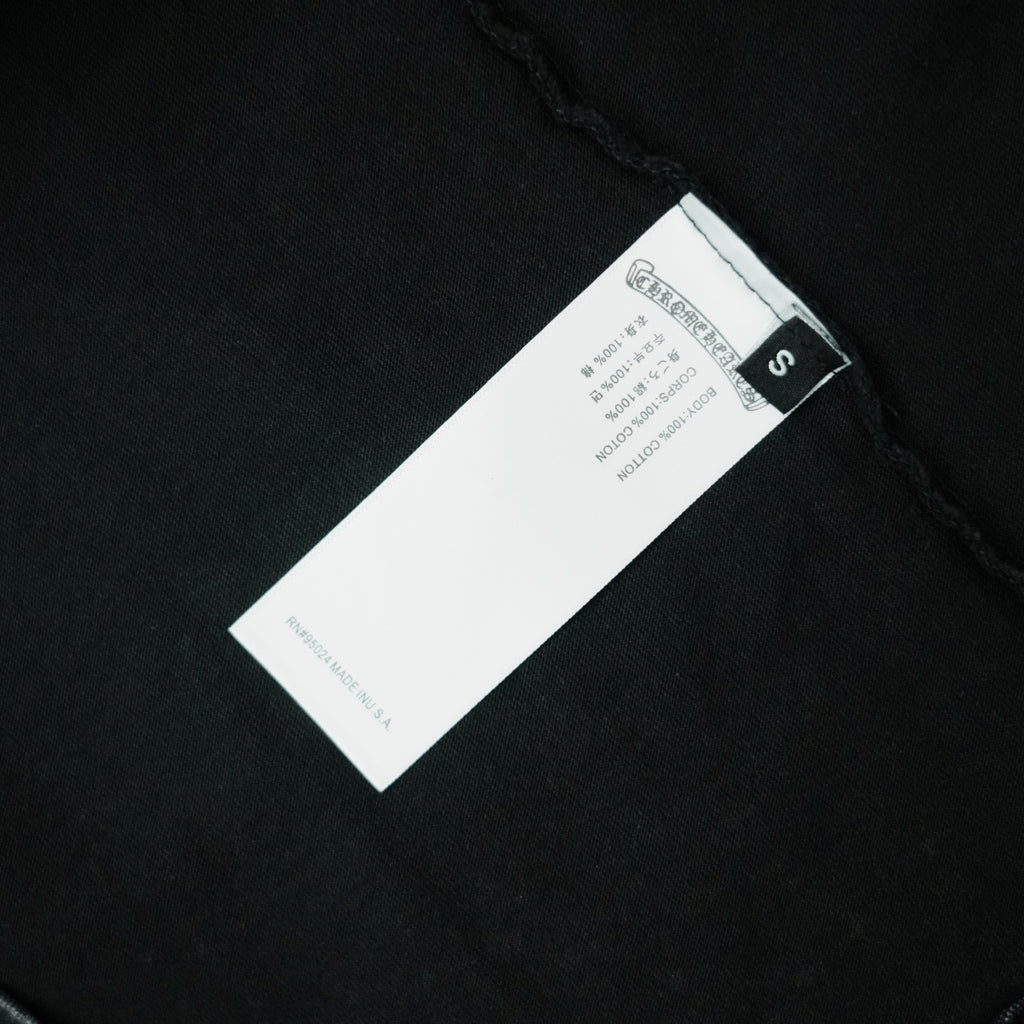 Black T-shirt care label at side seam with size tag