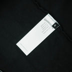 Black T-shirt interior care label and size tag near hem