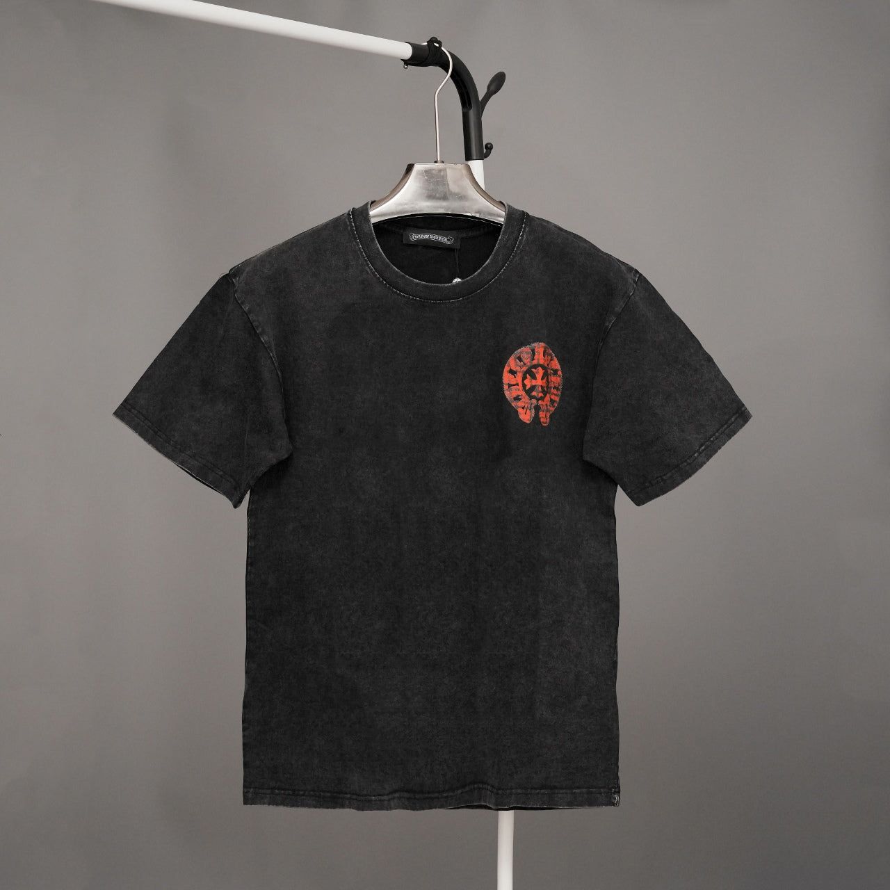 Black graphic T-shirt with red emblem on the chest
