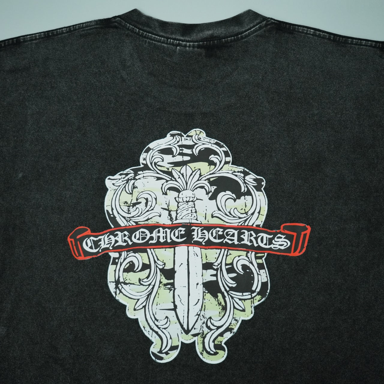 Black short-sleeve T-shirt back graphic with ornate crest and red banner