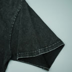 Black short-sleeve T-shirt sleeve and hem close-up with visible stitching