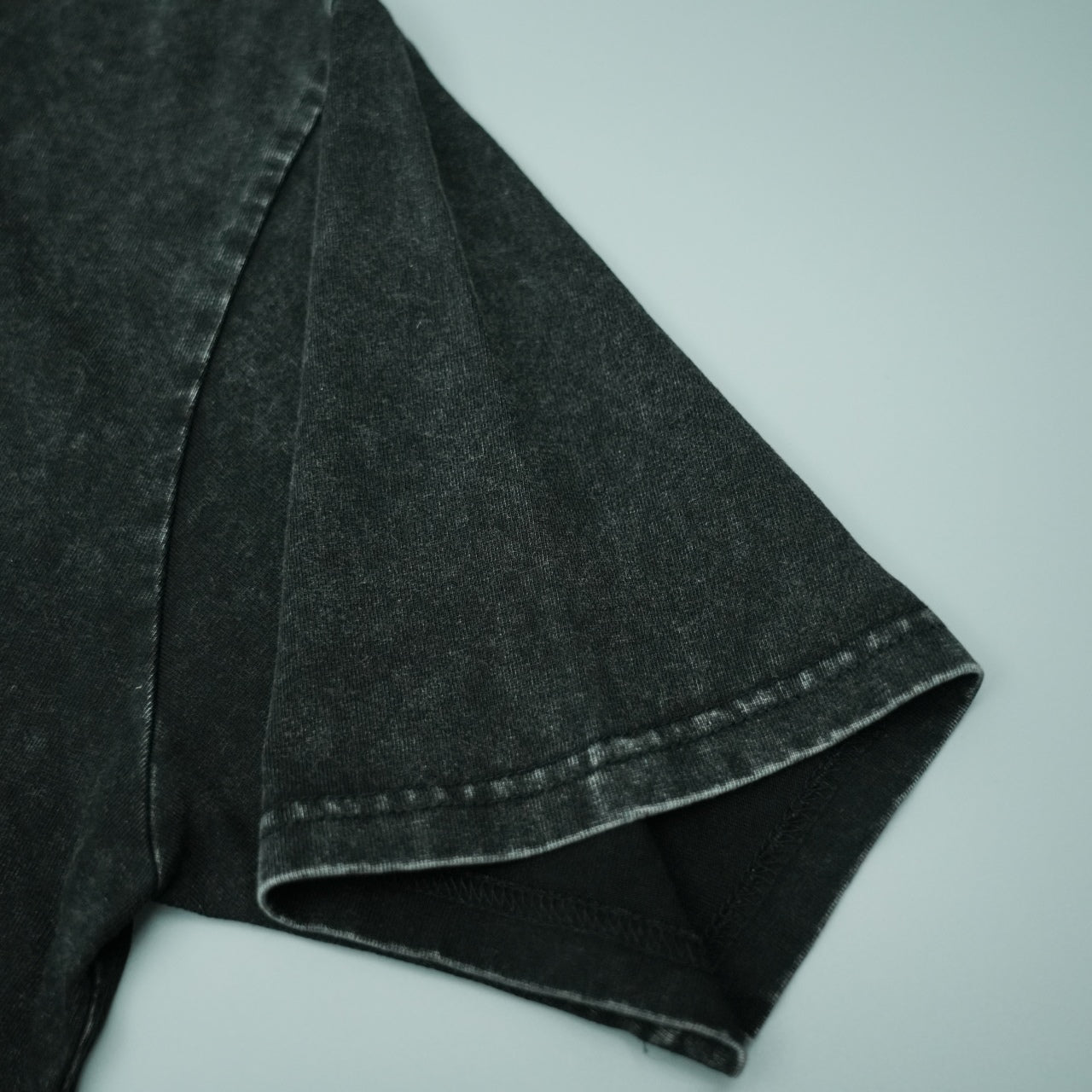 Black T-shirt short sleeve hem with visible double-stitched edge