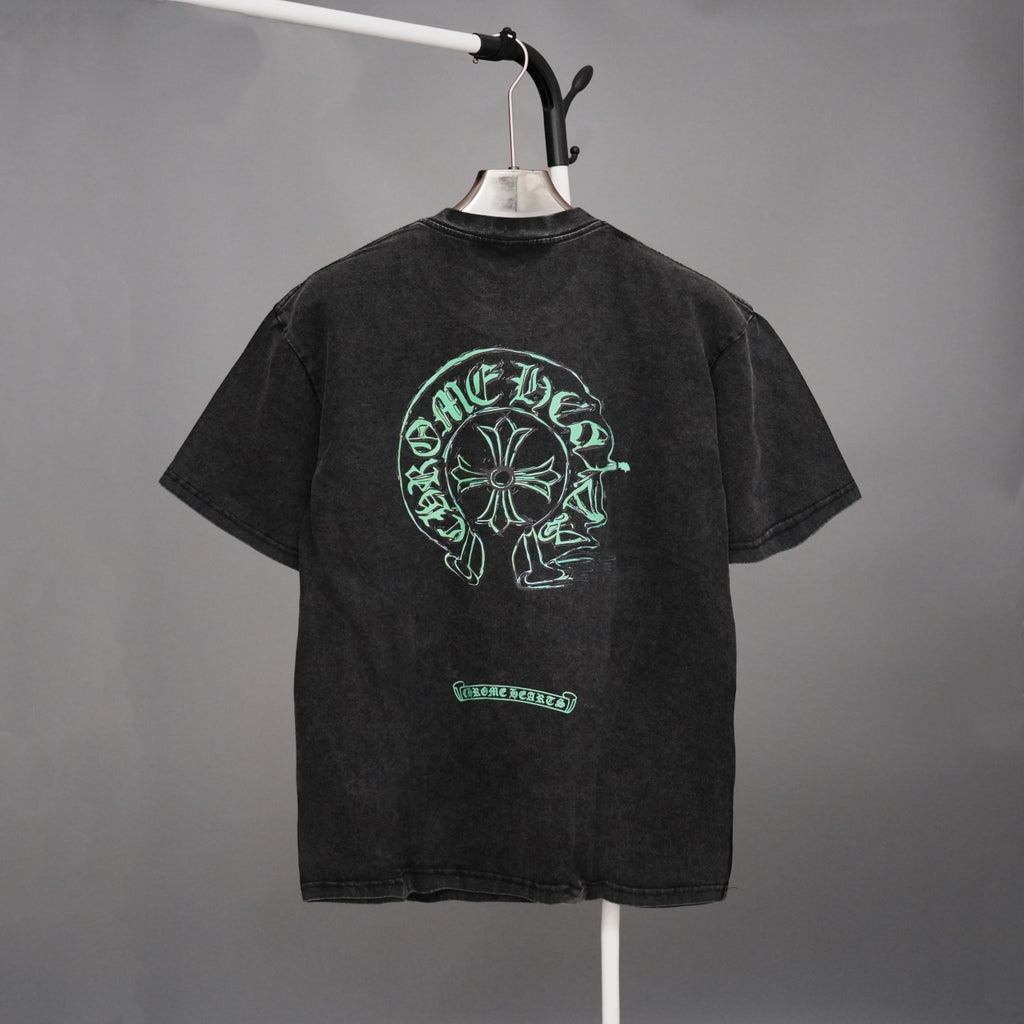 Black graphic T-shirt with large green head emblem on back and small chest graphic