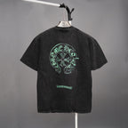 Black graphic T-shirt with large green head emblem on back and small chest graphic