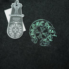 Black T-shirt with green head graphic print and attached white hang tag