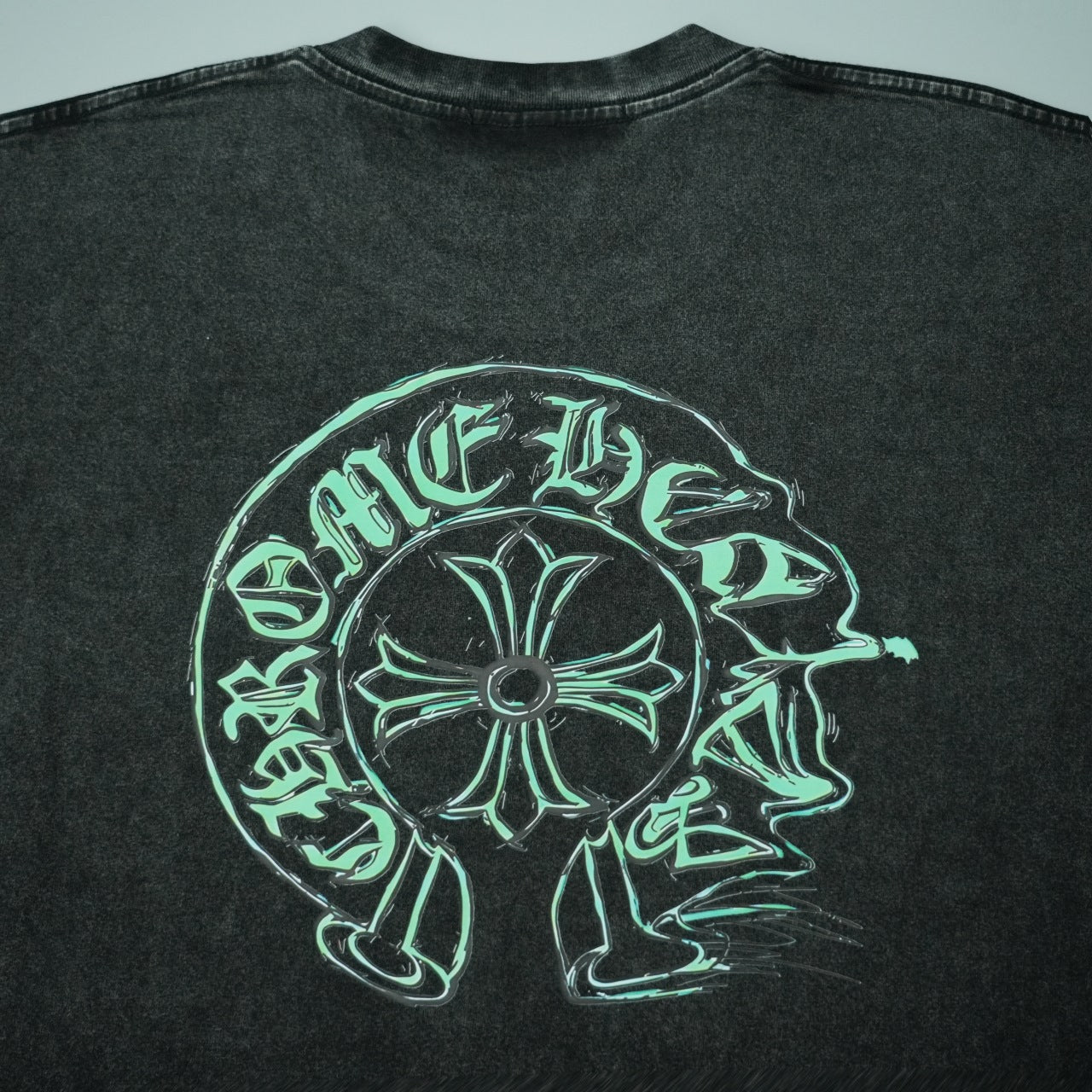 Black T-shirt with large green outline head graphic across back