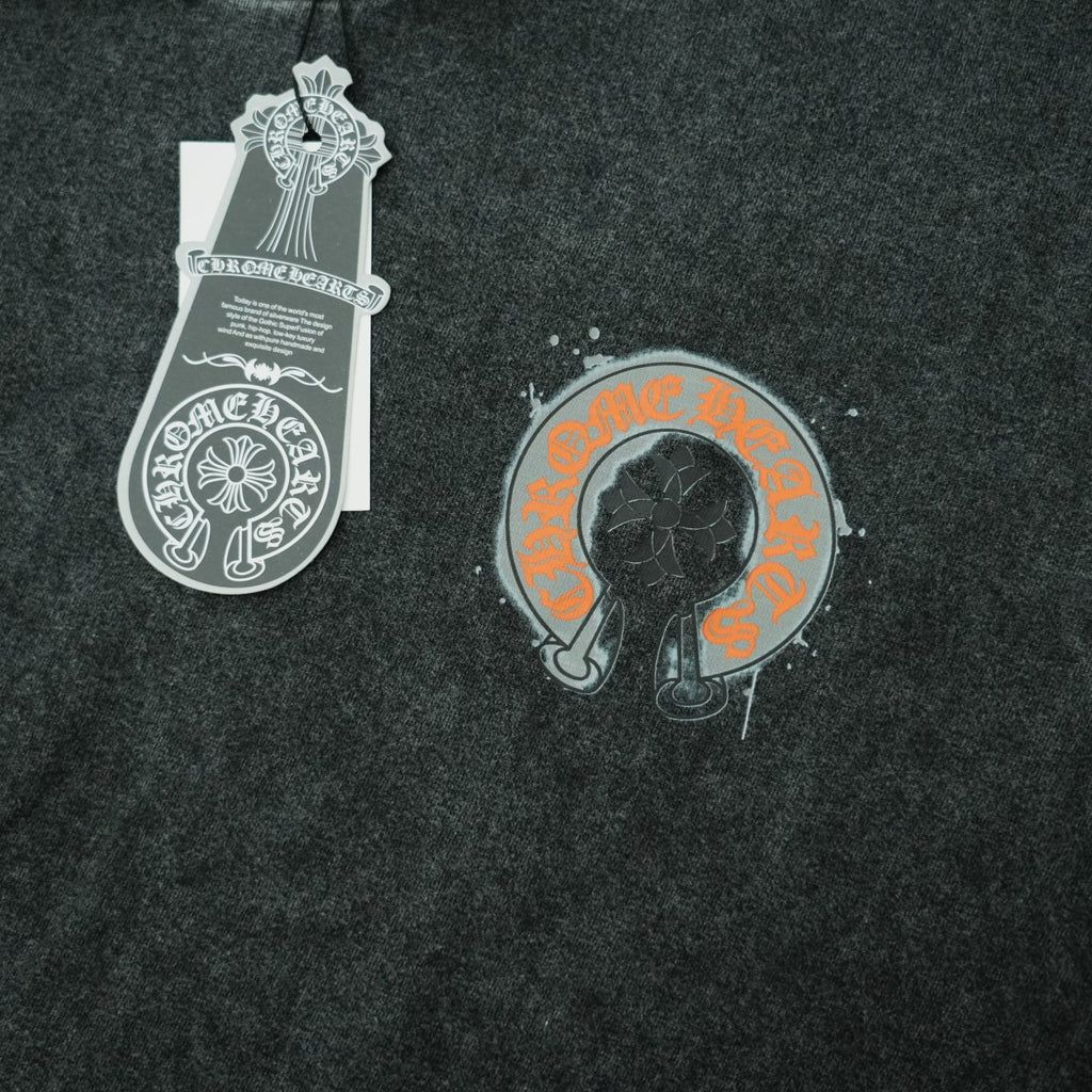 Dark gray T-shirt with hanging tag and chest graphic of black face in circle