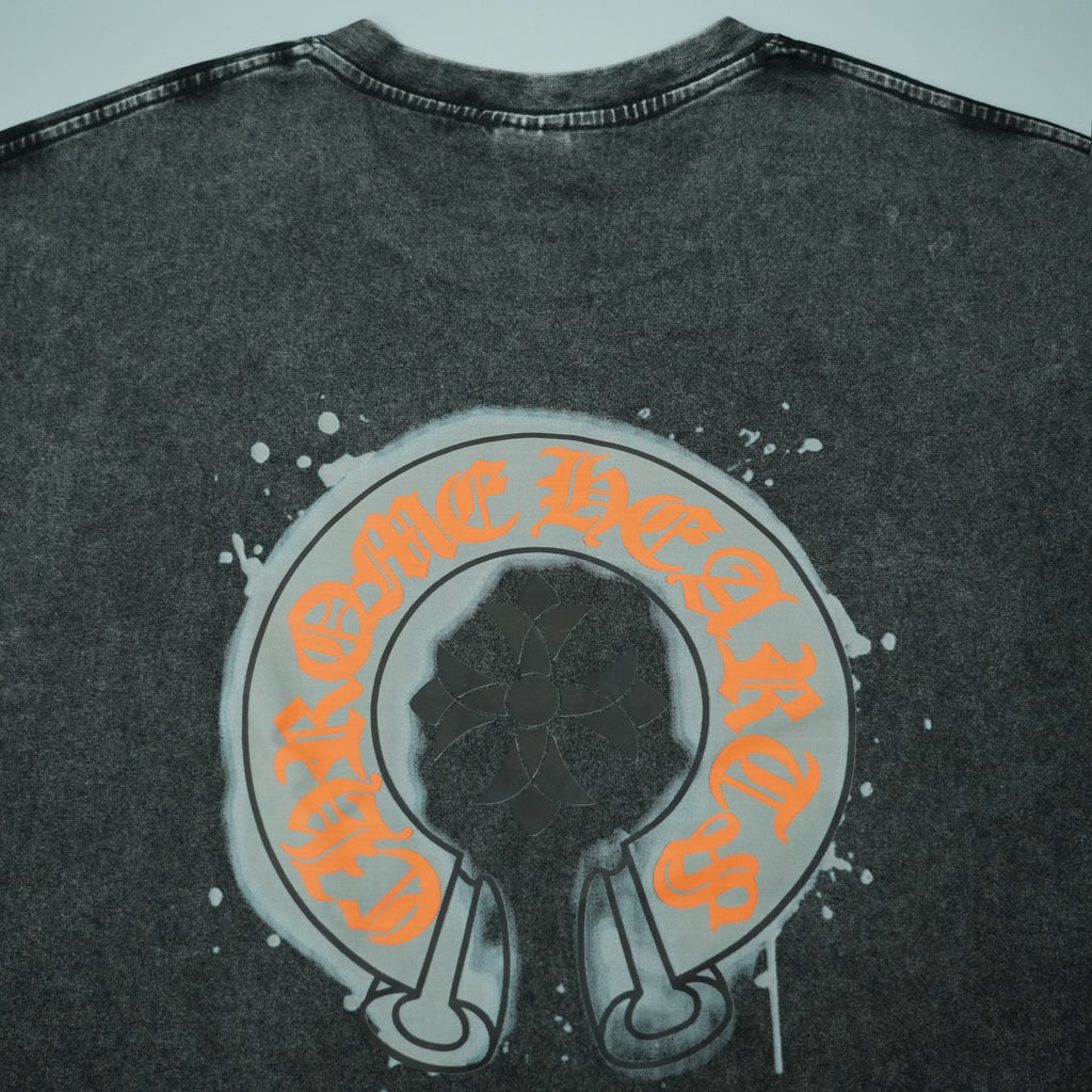 Dark gray T-shirt with large central round face graphic in orange and black