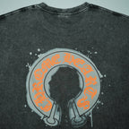 Dark gray T-shirt with large central round face graphic in orange and black