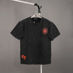 Black short-sleeve T-shirt with red crest logo on chest and small red mark