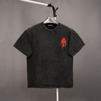 Dark short-sleeve T-shirt with small red graphic on the chest