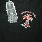 Black T-shirt detail with red-and-white front graphic and care tag