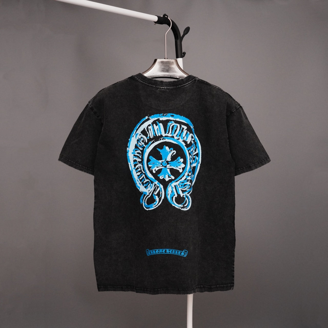 Black short-sleeve T-shirt with large blue back graphic on a hanger
