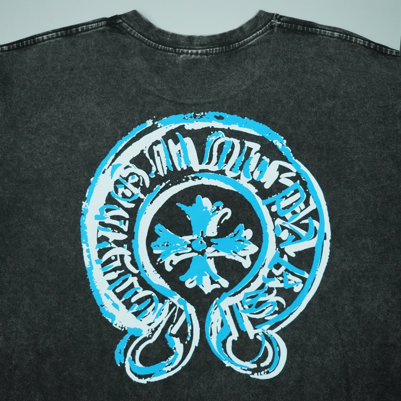 Black short-sleeve T-shirt front graphic featuring a large blue circular logo
