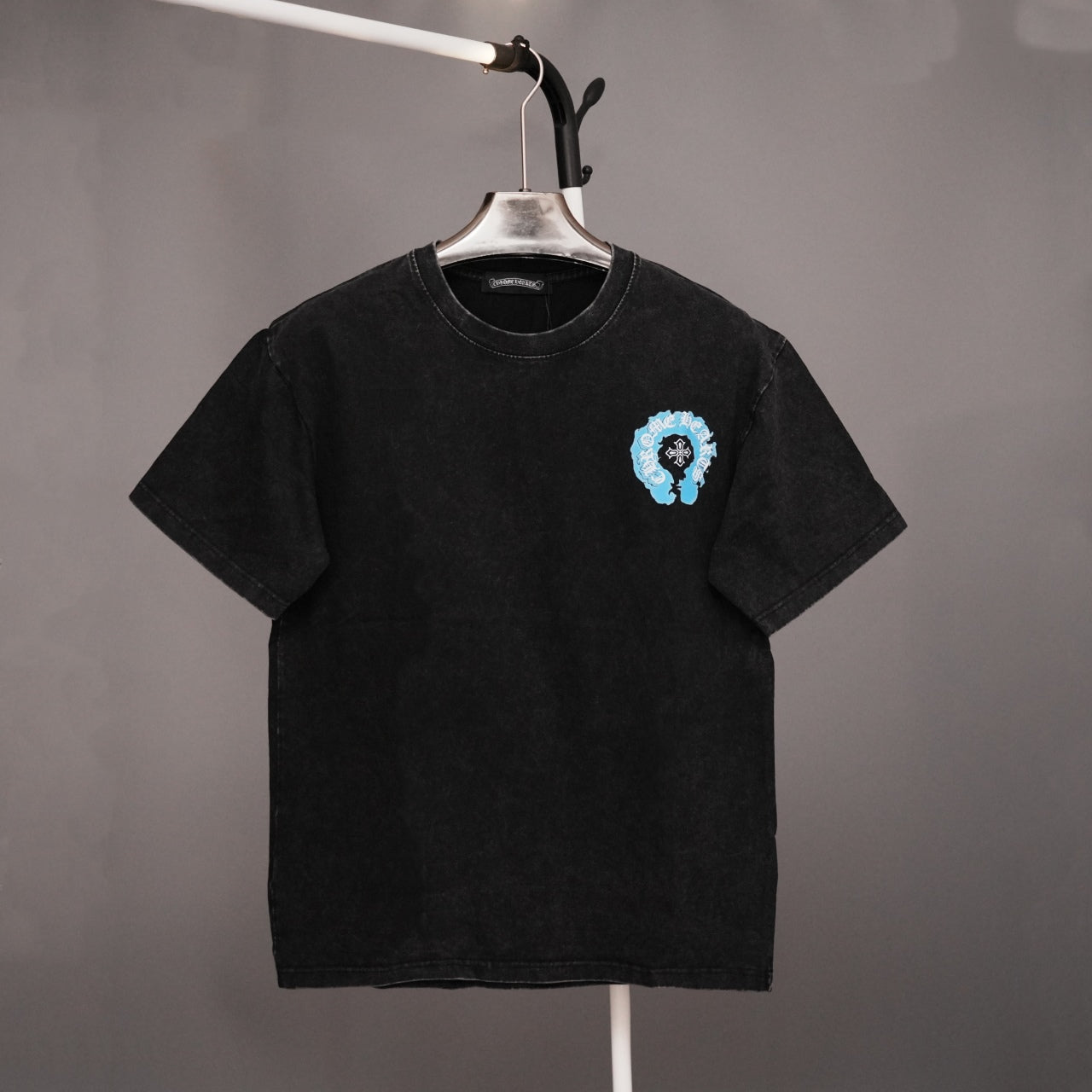 Black short-sleeve T-shirt with small blue graphic on left chest