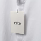 Dior clothing tag on white shirt, DIOR logo on hanging label