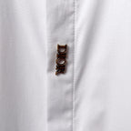 Dior long-sleeve shirt cuff with button detail, white fabric close-up