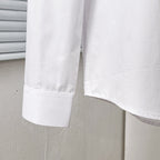 Dior long-sleeve shirt hem and sleeve cuff, white, side close-up