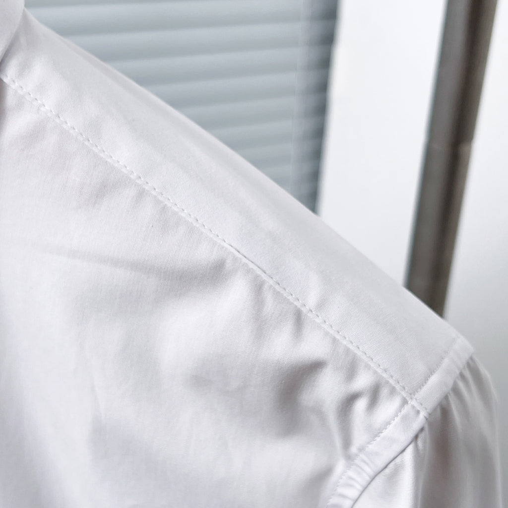 Dior long-sleeve shirt shoulder seam detail, white fabric close-up