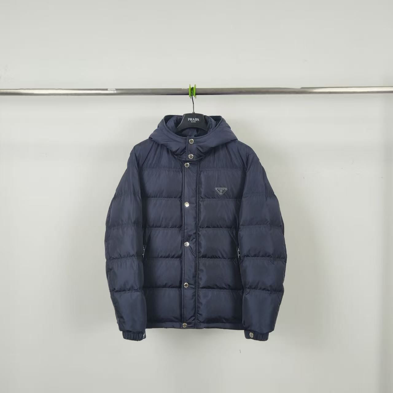 Dark navy puffer jacket with hood and button front