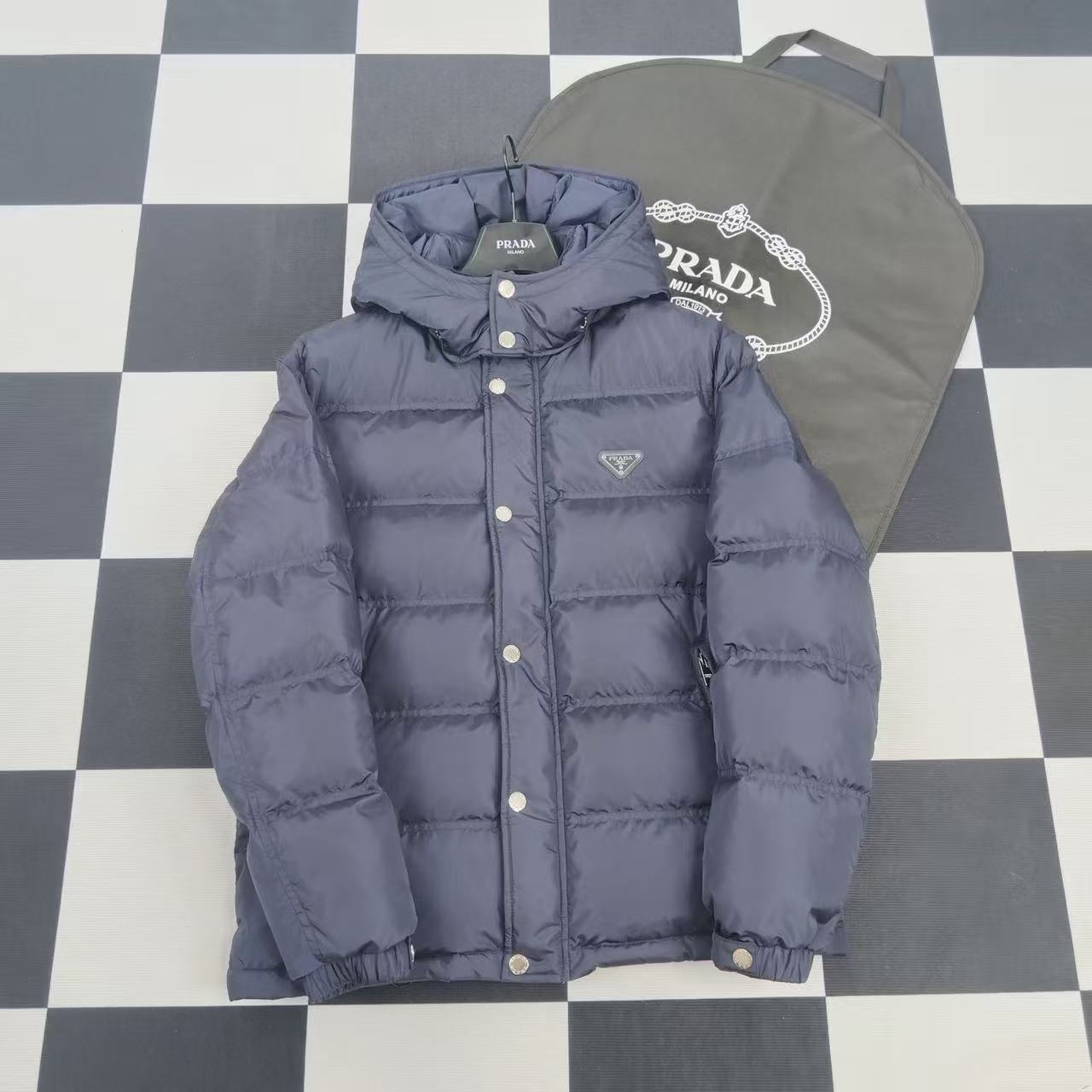 Navy hooded puffer jacket with button front and logo patch