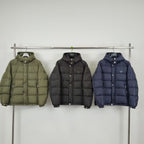 Olive puffer jacket with hood, button front, and front pockets