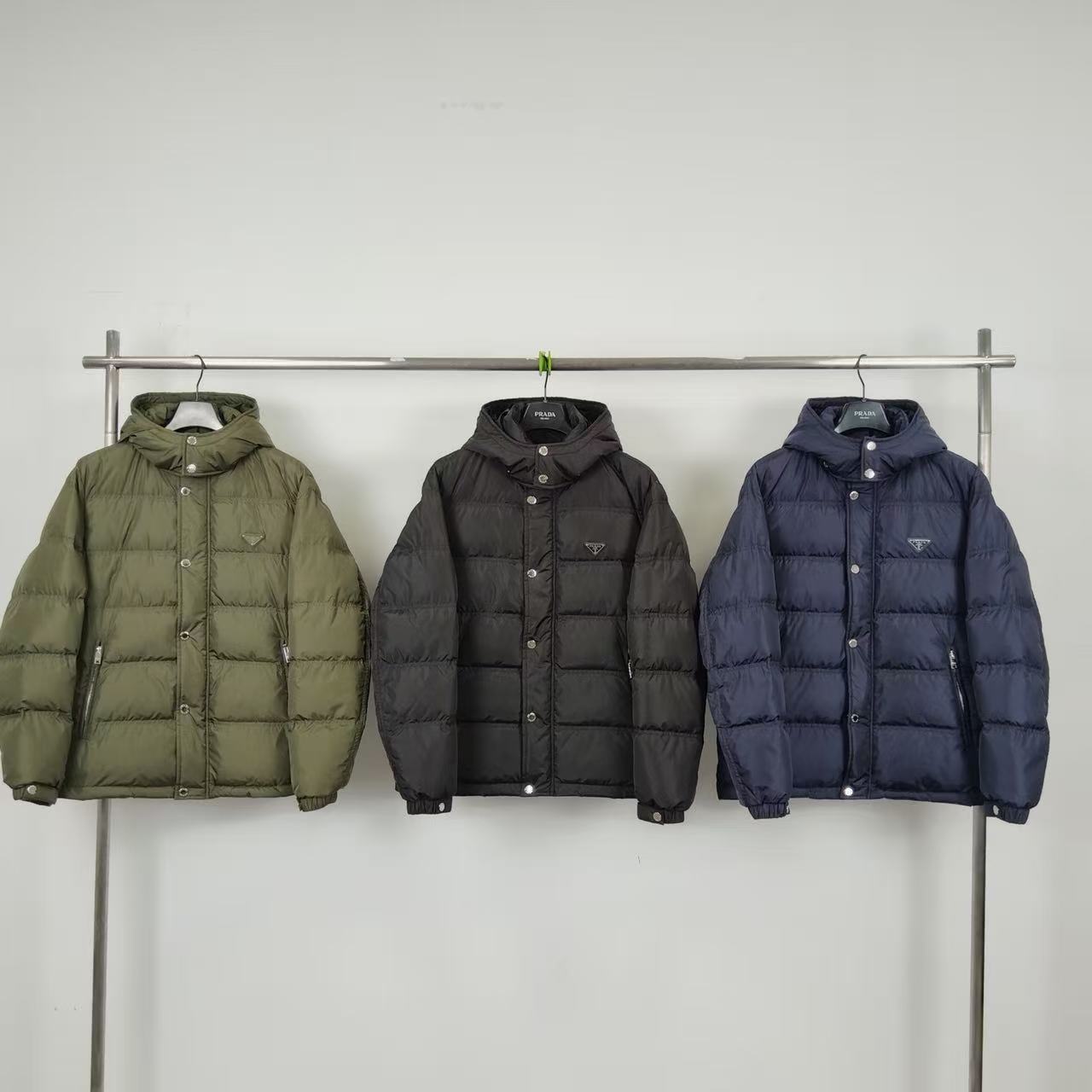 Olive puffer jacket with hood, button front, and front pockets