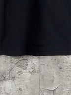Black long-sleeve T-shirt hem with small embossed logo detail
