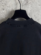 Black crewneck T-shirt back yoke area with stitched collar and hanging loop