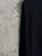 Long-sleeve crewneck shirt side-back view with dark fabric and flat seams