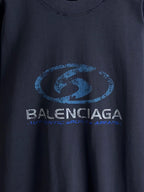 Balenciaga dark blue crewneck top with oval logo and small tagline beneath