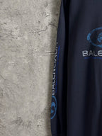Balenciaga dark blue long-sleeve top with vertical logo text on sleeve